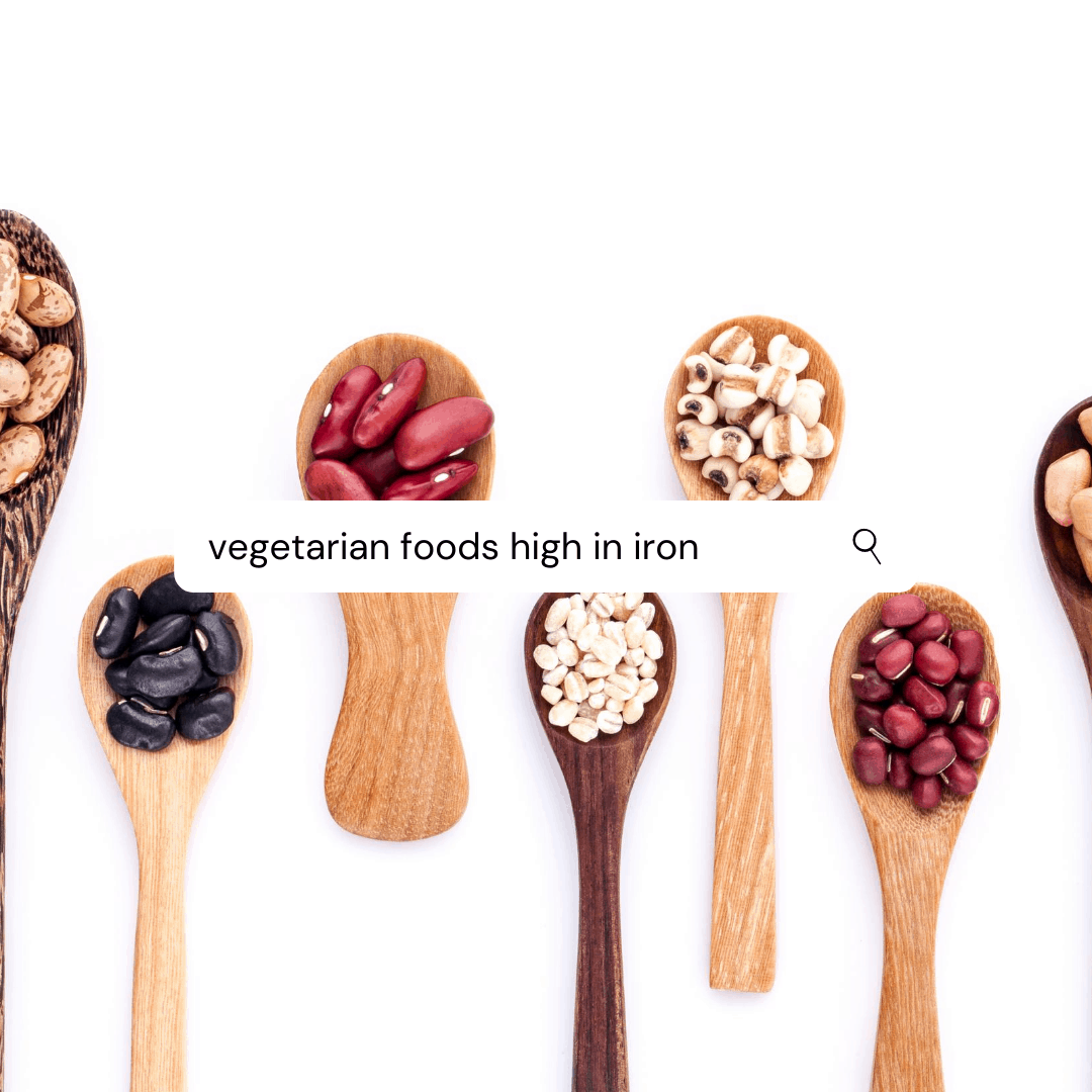 a line of wooden spoons each holding a different scoop of dry beans (pinto, black, peas). there is a search bar over the image that reads "vegetarian food high in iron"