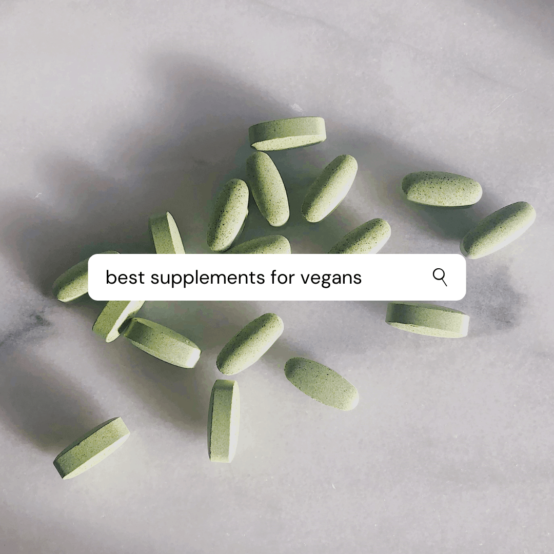 looking down on a scattering of green tablets on a tabletop with a text box over it saying "best supplements for vegans" 